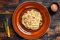 Italian Spaghetti Carbonara pasta with bacon, hard parmesan cheese and cream sauce. Dark Wooden background. top view Royalty Free Stock Photo