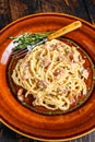 Italian Spaghetti Carbonara pasta with bacon, hard parmesan cheese and cream sauce. Dark Wooden background. top view Royalty Free Stock Photo