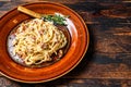 Italian Spaghetti Carbonara pasta with bacon, hard parmesan cheese and cream sauce. Dark Wooden background. top view. Copy space Royalty Free Stock Photo