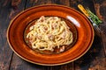 Italian Spaghetti Carbonara pasta with bacon, hard parmesan cheese and cream sauce. Dark Wooden background. top view Royalty Free Stock Photo