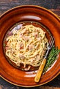 Italian Spaghetti Carbonara pasta with bacon, hard parmesan cheese and cream sauce. Dark Wooden background. top view Royalty Free Stock Photo