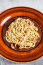 Italian Spaghetti Carbonara pasta with bacon, hard parmesan cheese and cream sauce. White background. top view Royalty Free Stock Photo