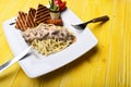 Italian spaghetti with chicken and mushrooms on square plate Royalty Free Stock Photo