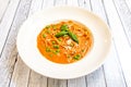 Italian spaghetti dish with peas, lots of seafood sauce and basil leaves