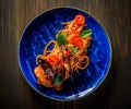 Italian spaghetti pasta marinara with Clams, Prawns, Mussels, tomato, Seafood Cocktail in blue plate on wooden table Royalty Free Stock Photo