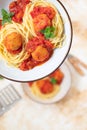 Italian spaghetti pasta with meat balls and tomato sauce served with oregano in two bowls on a light marble table. Top view, copy Royalty Free Stock Photo