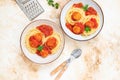 Italian spaghetti pasta with meat balls and tomato sauce served with oregano in two bowls on a light marble table. Top view, copy Royalty Free Stock Photo