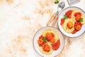 Italian spaghetti pasta with meat balls and tomato sauce served with oregano in two bowls on a light marble table. Top view, copy Royalty Free Stock Photo