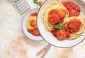 Italian spaghetti pasta with meat balls and tomato sauce served with oregano in two bowls on a light marble table. Top view, copy Royalty Free Stock Photo