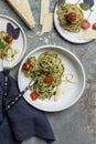 Italian spaghetti with pesto, herbs and cherry tomatoes at white plate Royalty Free Stock Photo
