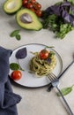 Italian spaghetti with pesto, herbs and cherry tomatoes at white plate Royalty Free Stock Photo