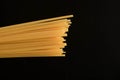 Italian spaghetti raw pasta, dark background