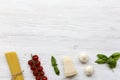 Italian spaghetti, tomatoes, parmesan, basil and garlic. Igredients for cooking pasta, top view. Royalty Free Stock Photo