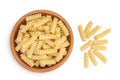 Italian spiral shaped pasta, Fusilli bucati macaroni in ceramic bowl, isolated on white background. Top view. Flat lay. Royalty Free Stock Photo