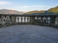 Italian stone balustrade illuminated by sun rays and water in the background Royalty Free Stock Photo