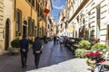 Rome/Italy - August 27, 2018: Busy Roman Street with Fashionable City People, Boutiques and Motor Scooters parking Royalty Free Stock Photo