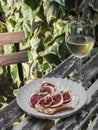 Italian style aperitif - bruschetta with cheese, figs, honey, nuts and a glass of white wine on a table in an outdoor cafe Royalty Free Stock Photo