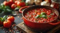 italian-style cooking bubbling sugo sauce in red pot on stove, rustic background traditional concept Royalty Free Stock Photo