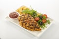 Italian style marinated chicken breast with fresh salads and tomato catchup on white rectangle