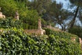 Italian style Mediterranean garden. tone statues surrounded by vegetation. Mallorca, Spain. Royalty Free Stock Photo