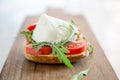 Italian style toast with light bread, arugula, tomato and mozzarella cheese Royalty Free Stock Photo