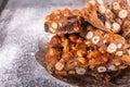 Italian sweet nuts, hazelnuts, almonds, figs, honey dessert over on sugar powder surfase