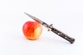 Italian switchblade knife and apple.