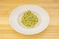 Italian tagliatelle pasta recipe with pesto and pistachio sauce on white plate Royalty Free Stock Photo
