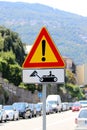 Italian temporary warning sign `Other danger` with additional panel `Construction vehicles at work`