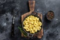 Italian tortellini pasta with cheese sauce in a pan. Black background. Top view Royalty Free Stock Photo
