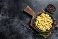 Italian tortellini pasta with cheese sauce in a pan. Black background. Top view. Copy space Royalty Free Stock Photo