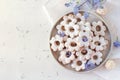 Italian traditional cookies are canestrelli on a white background with flowers. Homemade pastries. The concept of Royalty Free Stock Photo