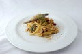Italian Traditional DishSpaghetti con le sarde on plate with white table background.
