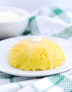 Italian traditional Polenta, porridge made from cornmeal. Mamaliga With Cottage Cheese and sour cream. Organic food.