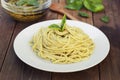 Italian traditional spaghetti with basil pesto pasta with cheese, pine nuts, olive oil, rustic table. View from above. Royalty Free Stock Photo