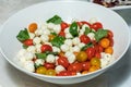 Italian tricolore, small balls of fresh white soft Italian mozzarella cheese, ripe red cherry tomatoes and fresh green