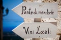 Italian typical products wooden arrow signs. Pointing left. Outdoor Royalty Free Stock Photo