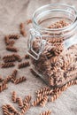 Italian unprepared pasta in a glass jar - fusilli