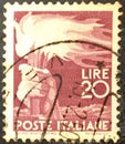 Italian used postage stamp depicting a hand with a torch