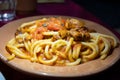 Italian vegetarian dish macaroni with golden chanterelles mushrooms and tomatoes