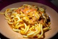 Italian vegetarian dish macaroni with golden chanterelles mushrooms and tomatoes