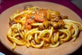 Italian vegetarian dish macaroni with golden chanterelles mushrooms and tomatoes