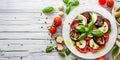 Italian vegetarian plate on white wooden table in restaurant featuring caprese salad eggplant Royalty Free Stock Photo