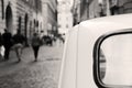 An italian vintage car parked in the streets of Rome, a nun walking on the background. Royalty Free Stock Photo