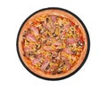 Italian whole pizza with chicken breast, corn, bacon and mushrooms, on a round slate plate, isolated on white Royalty Free Stock Photo