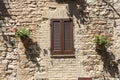 Italian Window with Wooden Shutters in a brick wall Royalty Free Stock Photo