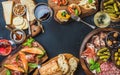 Italian wine antipasti snack variety over dark background