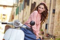 Italian woman sitting on a vintage scooter. Royalty Free Stock Photo