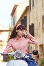 Italian woman sitting on a vintage scooter. Royalty Free Stock Photo