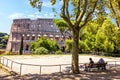 Italians rest on the playground in front of the Coliseum